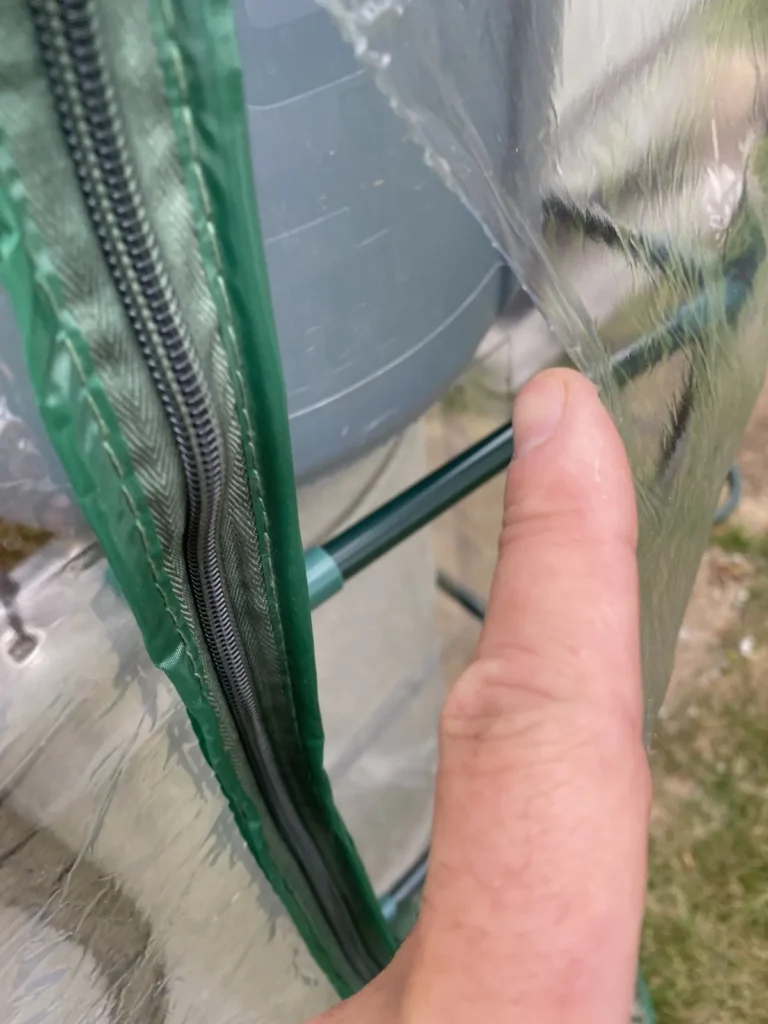 Close-up of a damaged seam on a plastic aquaponics enclosure