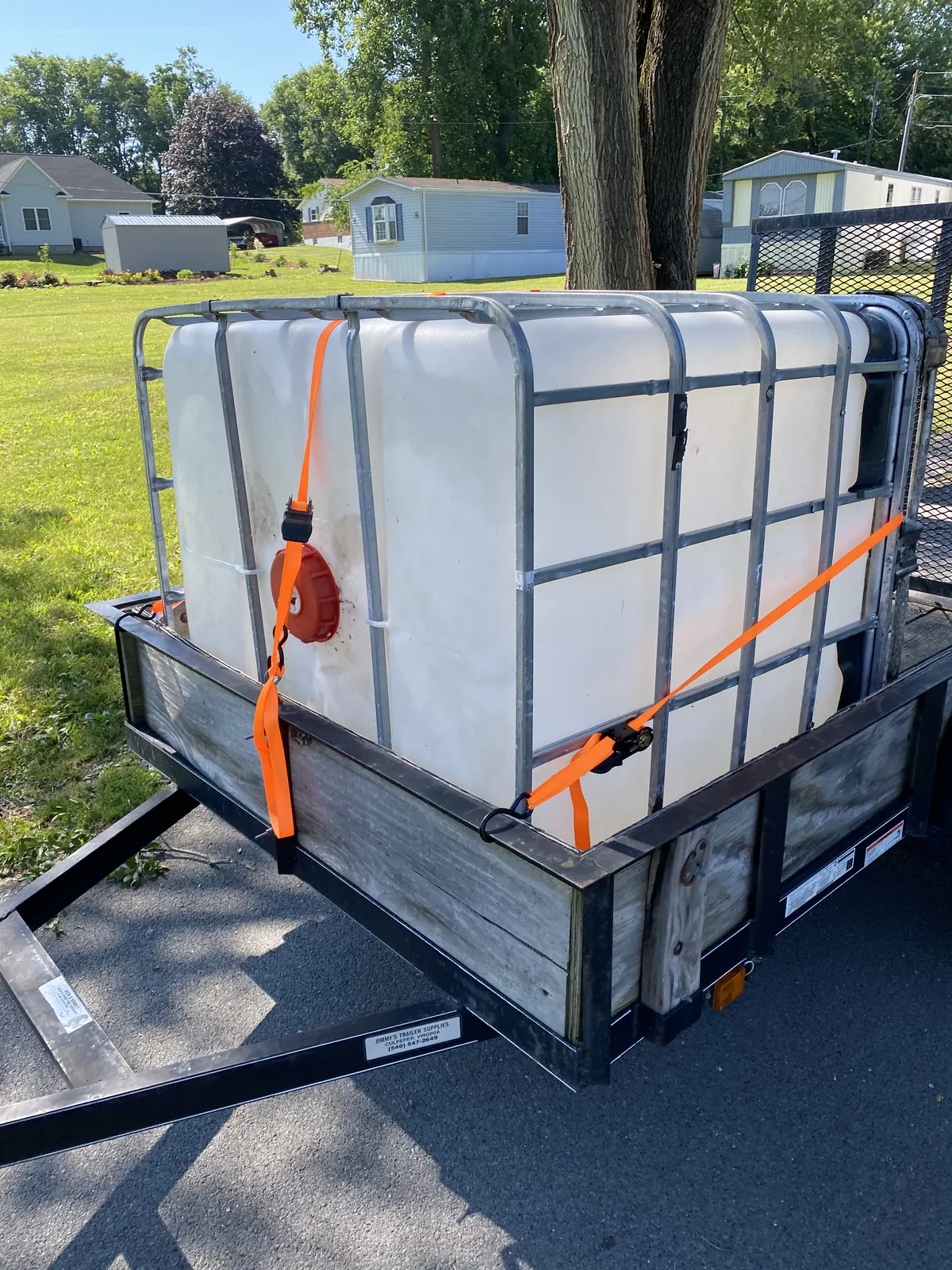 IBC tote secured to a utility trailer before an aquaponics build